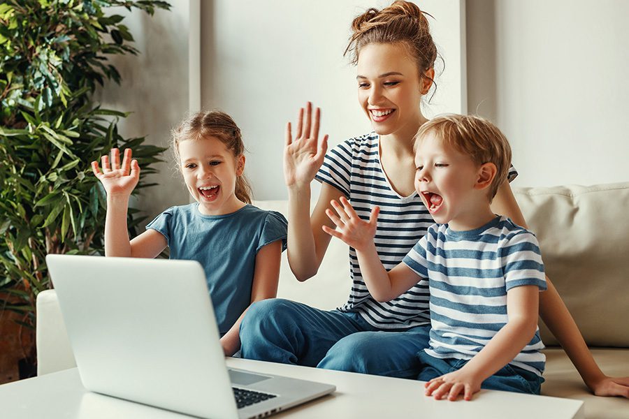 Client Center - Happy Mother With Her Two Kids Having a Video Call on a Laptop